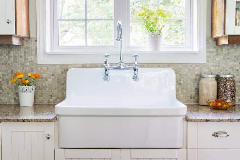 White Farmhouse Kitchen Sink Near Window