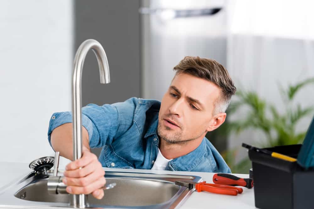 Plumber Repairing Faucet