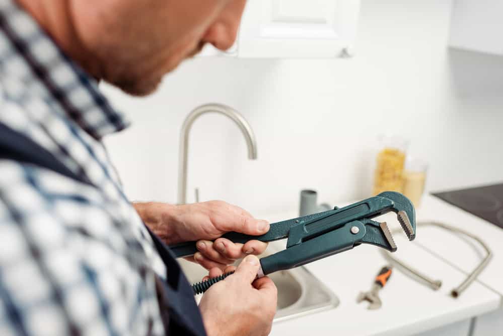 Plumber Fixing a Faucet
