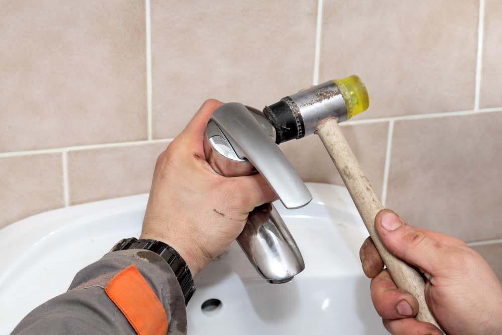 Plumber Repairing Faucet